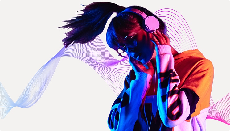 A rainbow colored scene shows a hand holding a shiny disco ball microphone in front of tropical plants with the Spotify premium logo in the corner