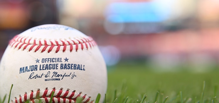 Close-up baseball on grass field.
