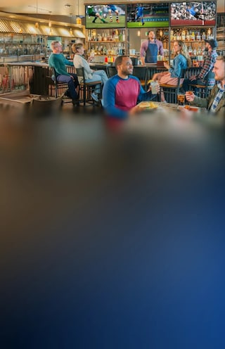 Sports bar with people enjoying game.