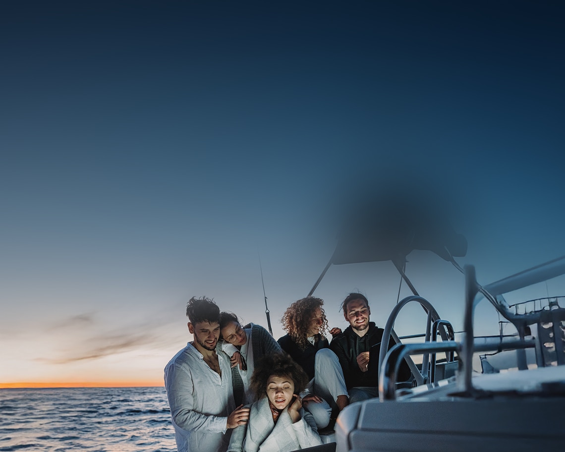 Group of friends on a boat. DIRECTV FOR BUSINESS.